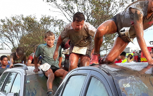 Brayden W getting stuck in at the Mud Run. 