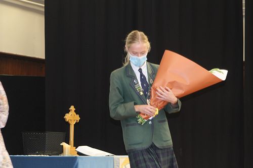 Annabelle Hurst, Head of House, receives flowers from Mrs Marianne Parks