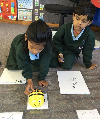 Prathiyuksha and Prathikram working together to programme the Bee-Bot to reach their chosen destination.