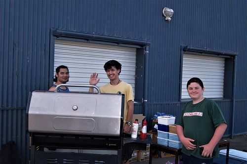 PTSA Helpers preparing barbecue sausages for the hungry hordes