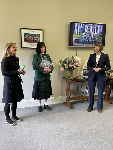 Angela Fu being presented with her prize by Ms Cecilia Madeleine