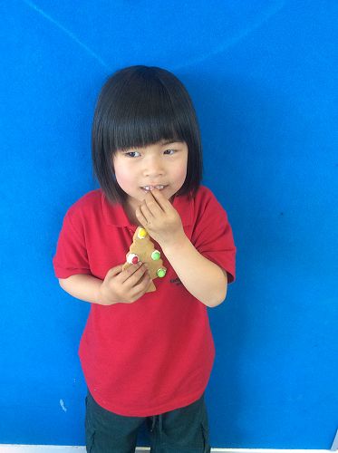 Natalie is enjoying her gingerbread tree.