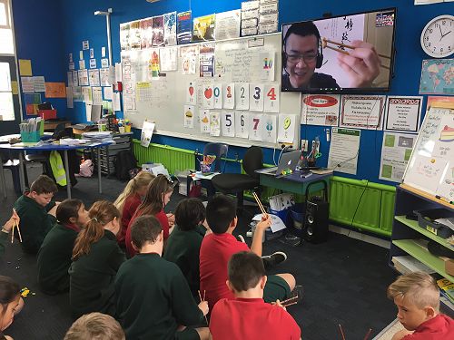 Following Mike's guidance on how to pick up the bean with chopsticks.