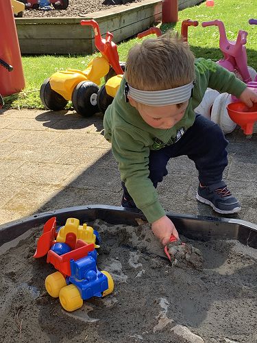 Oscar playing in the sandpit