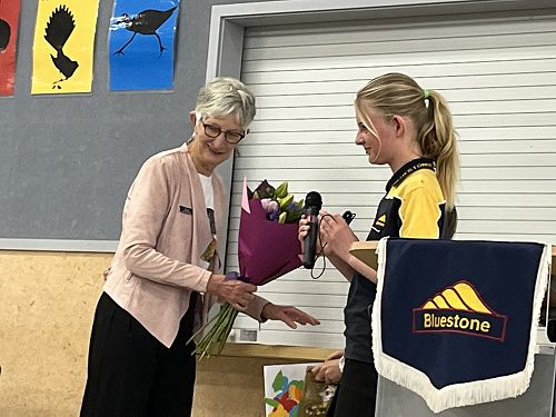 Emma presenting flowers and a speech to Mrs Ross