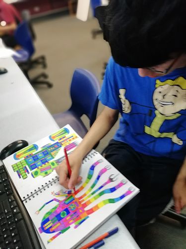 Josh works on his colourful illustration.