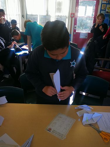 Ian constructing a Gypsy Moth plane from paper