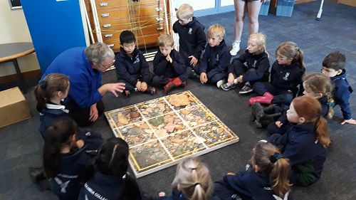 Shelley showing the students what they might find at the rocky shore.