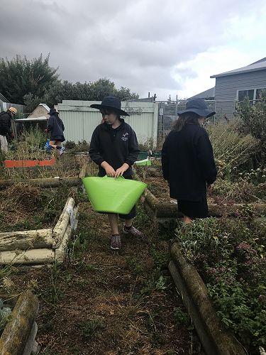Skye, Awhina, Anika helping to tidy up the garden.
