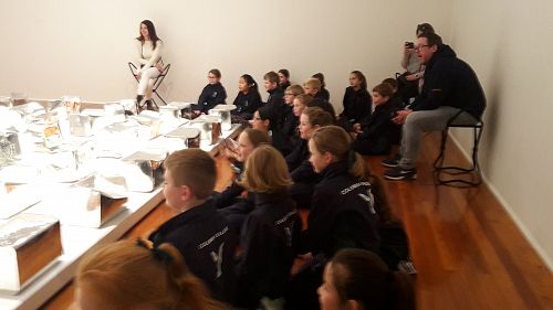 Year 5  students listening to the Artist in Residence from Tonga, Kalisolaite 'Uhila, speaking about the inspiration for his sculpture.