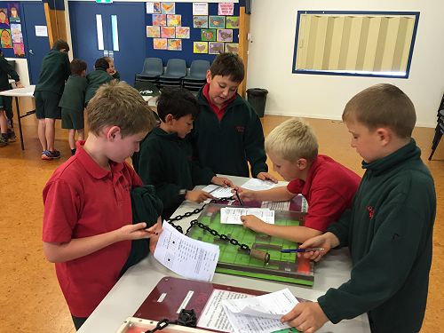 Josh, Ralph, Finnias, Josh and Yarek problem solve at the Maths Roadshow
