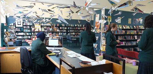Paper planes in flight in the library