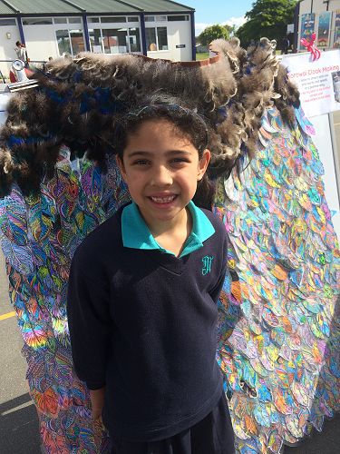 Alexis proudly showed the school korowai to her family.