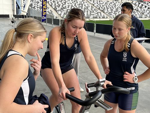 Teammates Briar and Bridgette supporting Millie on the cycle