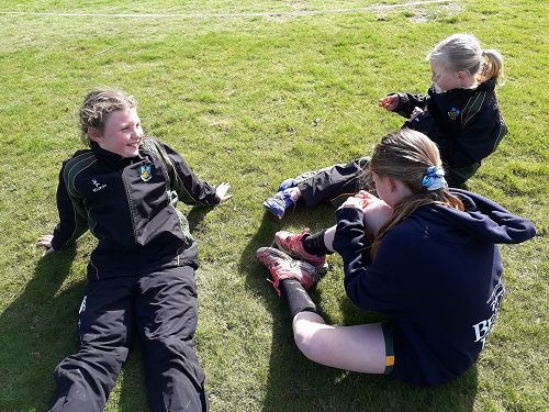 L-R Lilly Kemp, Kaitlyn O'Donnell and Ashley Howard relax after their race, Otago Primary Cross Country.