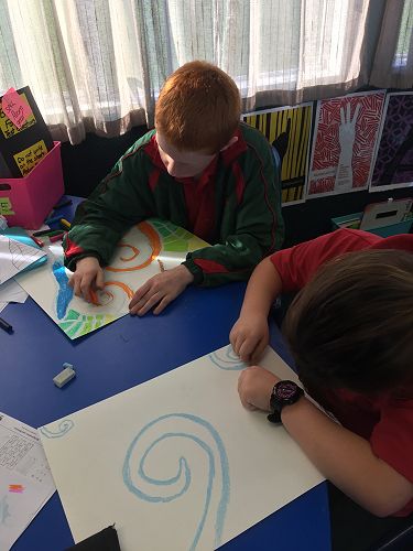 Devon and Brook working to complete their chalk and crayon koru patterns.