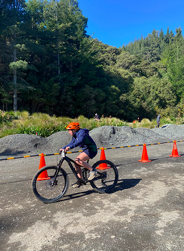 Anya Rhodes completing a lap of the mountain biking challenge for her team 