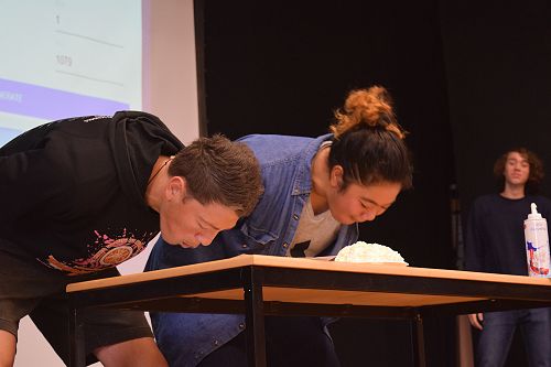 Student leaders Baylen and Vika face off in the chocolate cake eating competition.