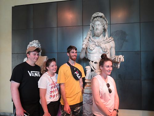 Charlie Gulter, Ruby Goodes, Toby Woolf and Chloe Buchanan pose beside the bust of Commodus, Capitoline Museum.