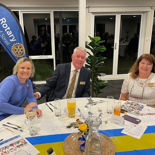 Brenda Holt, Graeme Holt and Chris Page at their table, changeover night
