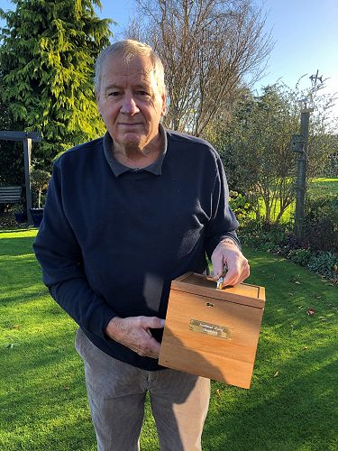 Stan Fissenden holds the box that contains the new chalice and paten.