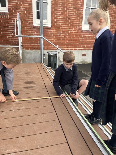 Look! I can measure like a pro with my feet, hands and ruler!