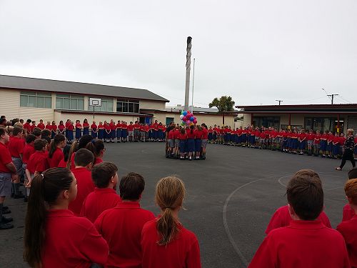 Chch assembly - outside holding balloons