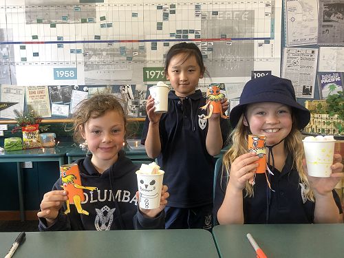 Years 0-3 with their creations; popcorn snowman cups and toilet roll loraxes.