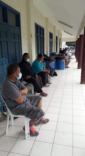 Waiting to collect their goods