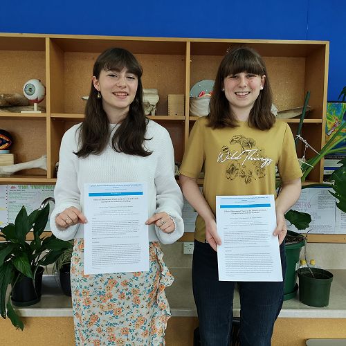 Olivia
and Maia hold the final drafts of their paper