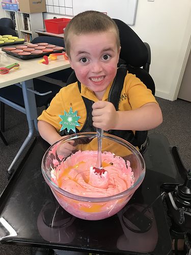Sam enjoying mixing the ingredients for Easter Marshmallow baskets.