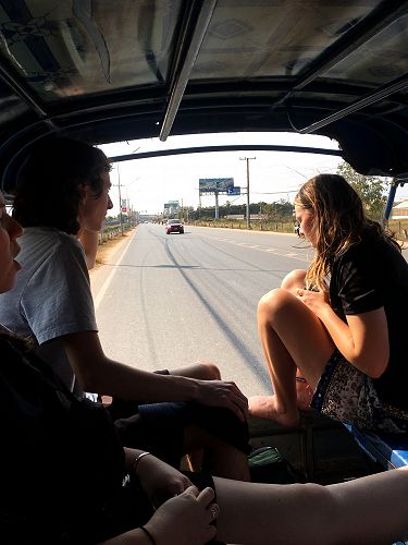 Hitching a ride on a tuk tuk.