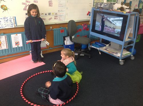 On stage, Ballet lesson to classical music are Maniah, Evie and Emily.