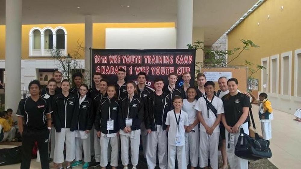 Whole group photo in the hotel lobby.