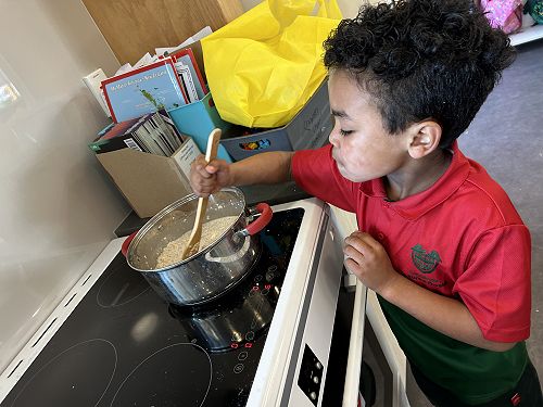 Leo stirring the porridge. How does the consistency change when we add heat?
