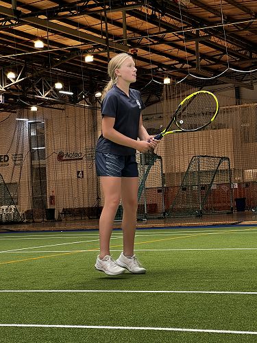 Alice waiting to hit a volley