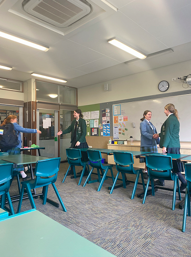 Columba and St Hilda's congratulating one another at the conclusion of the first debate