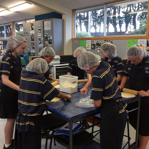 Careful concentration as students roll out their tortillas.