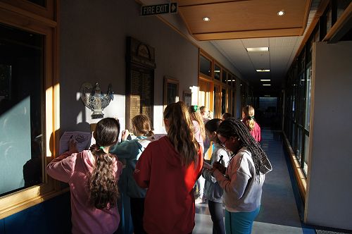 Year 7 students copy the motto from the Girton Lamp