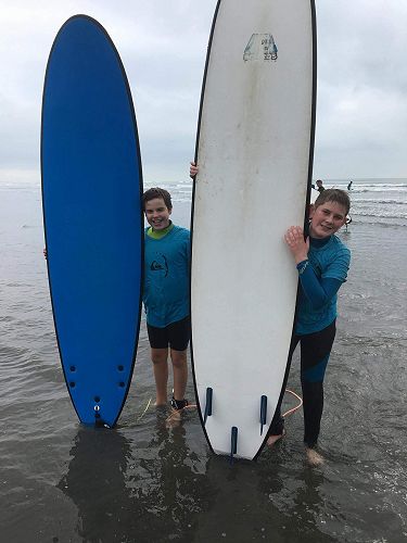 Maurice and Jaden with their surfboards