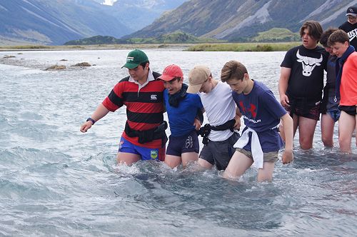 Robert, Tom, Aidan and Macauley practise river crossing in swifter water