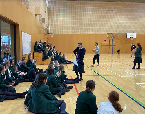 Jasmine Lobo-Linwood handing out prizes to the students who answer road safety questions correctly