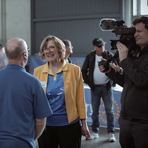 Roslyn Teirney holds the microphone as cinematographer Adam Reibel
films President Ricky Charles talking about the Rotary Club of Burnie West's
ferret race fundraiser at Rotary Tasmania Expo on Sat 25 March