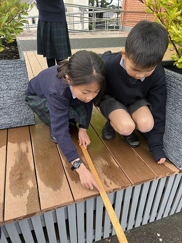 Look! I can measure like a pro with my feet, hands and ruler!