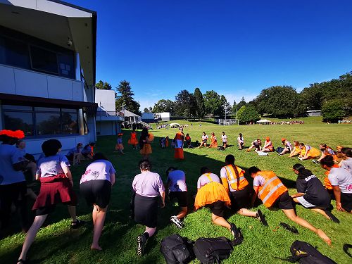 Year 10 Athletics Standards group stretch before the 100 metre!