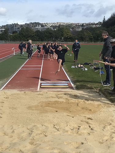 Lexi flying into the Long Jump Pit.