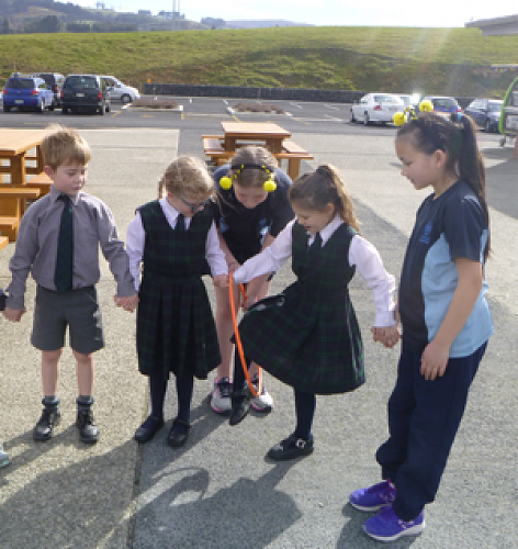 Oscar De Pelsemaeker, Samantha Mundy, Gracie Fisher and helpers from St Hilda's and Maori Hill completing problem solving tasks.