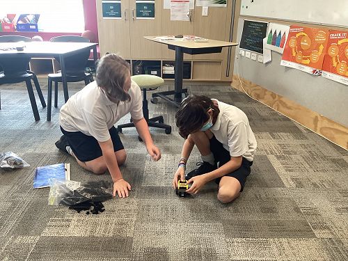 Sean and Lawsyn supporting each other to explore new resources and make new friendships.