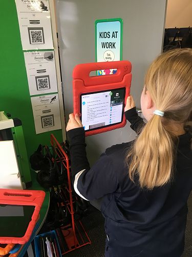 Students use a very simple QR code in Seesaw to share their learning with their parents