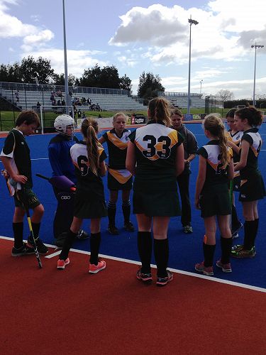 Half time discussion with the coach for the Hockey Team